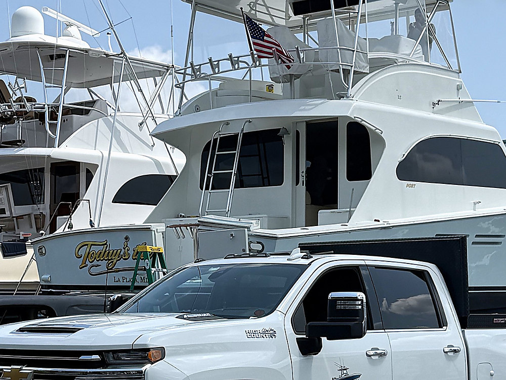 A sportfishing boat back in the water after its rigging work