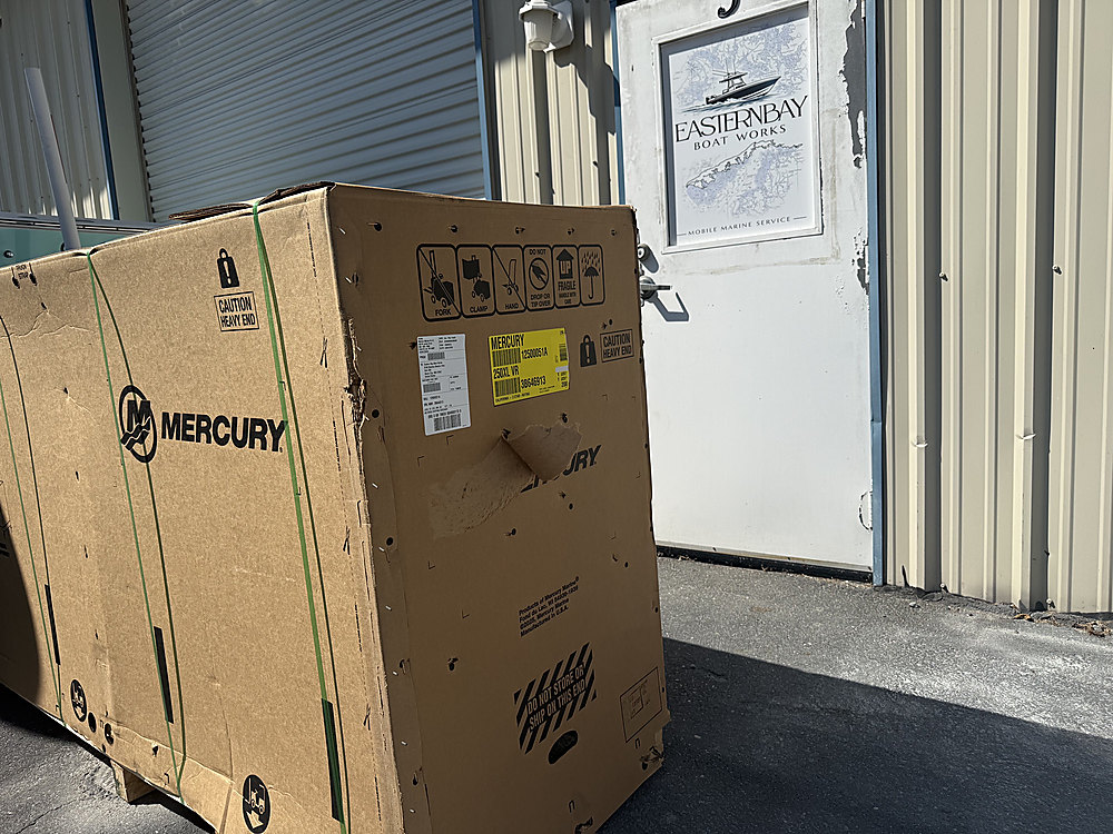 A crated Mercury outboard delivered outside the Eastern Bay Boat Works shop